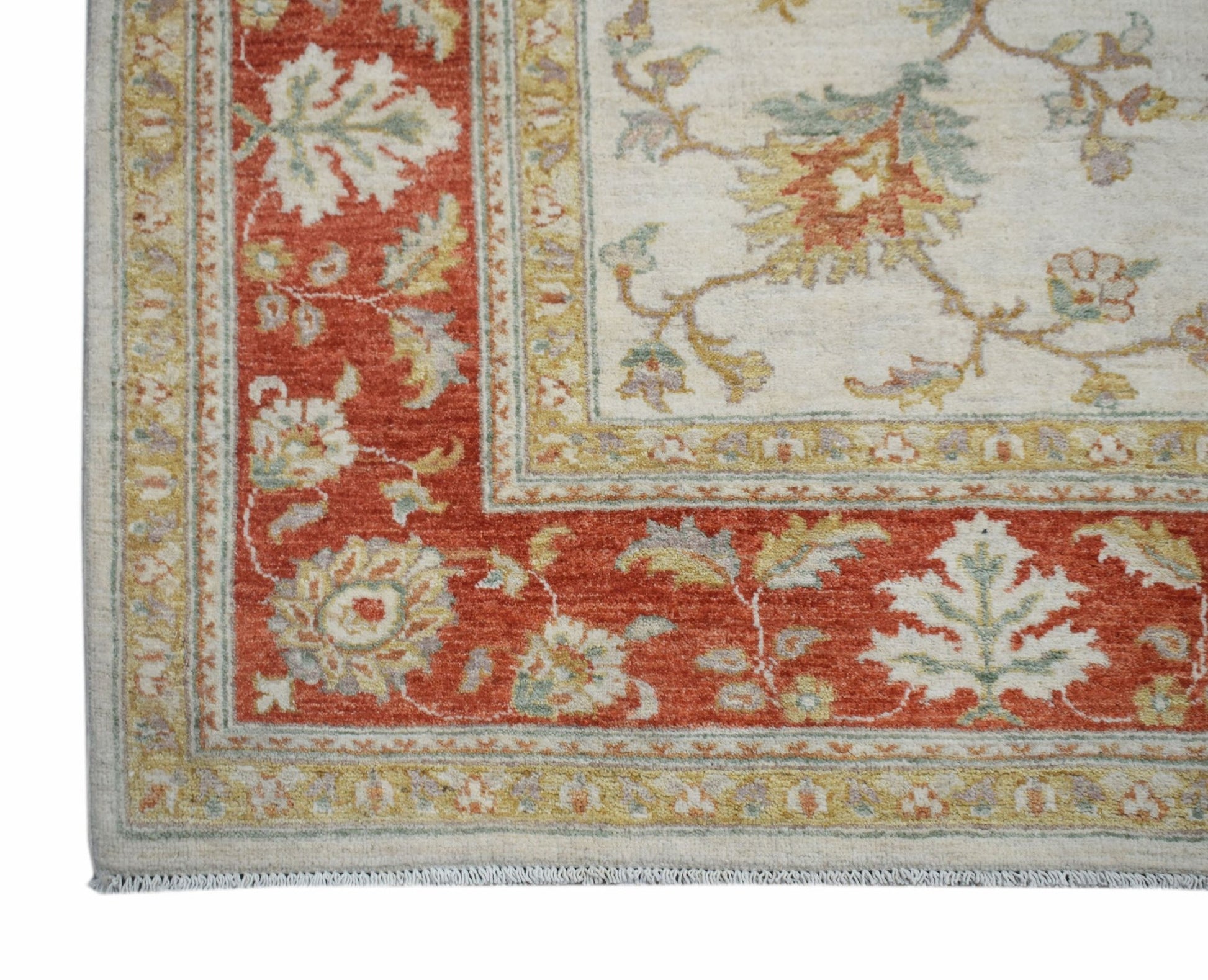 A handwoven Afghan Chobi rug featuring a floral pattern in red, cream, and muted earth tones.