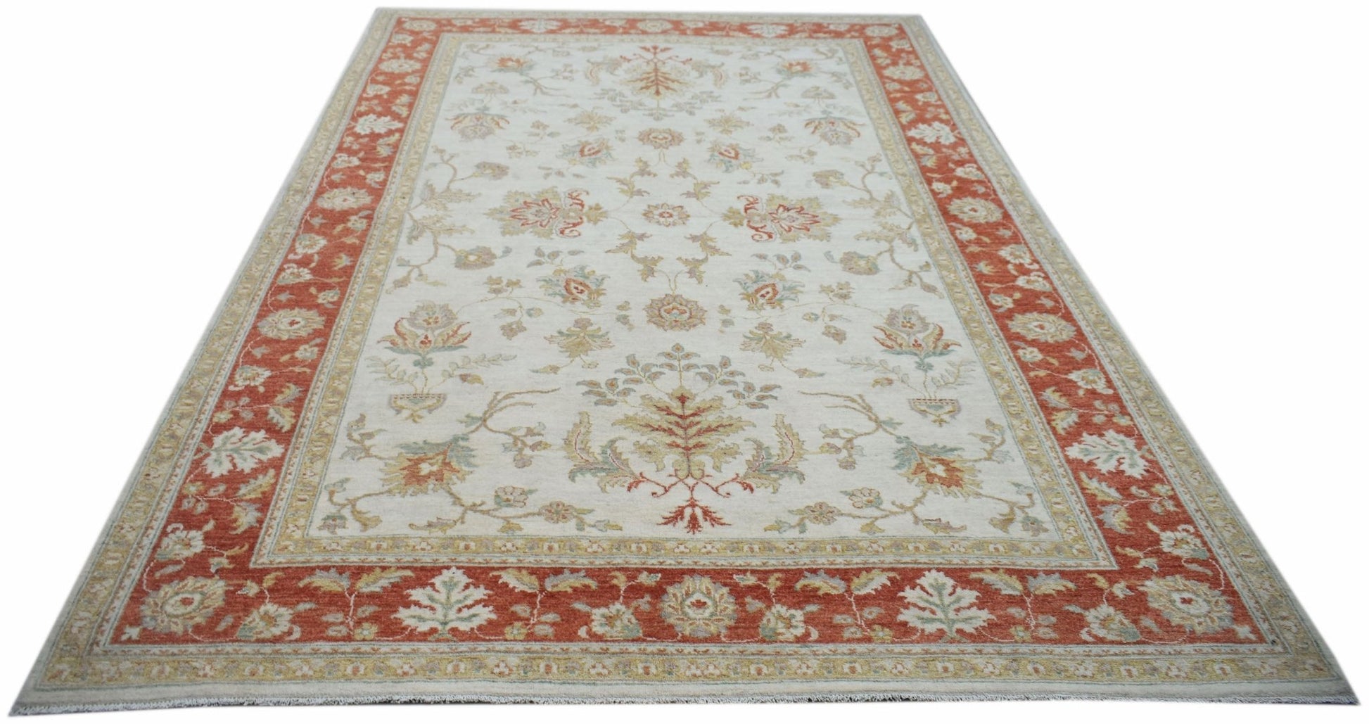 An Afghan Chobi rug featuring a traditional floral pattern in rust and cream tones.
