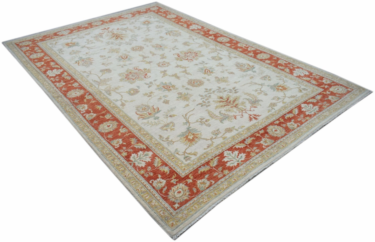 An Afghan Chobi rug featuring a cream field with floral patterns and a wide terracotta border.