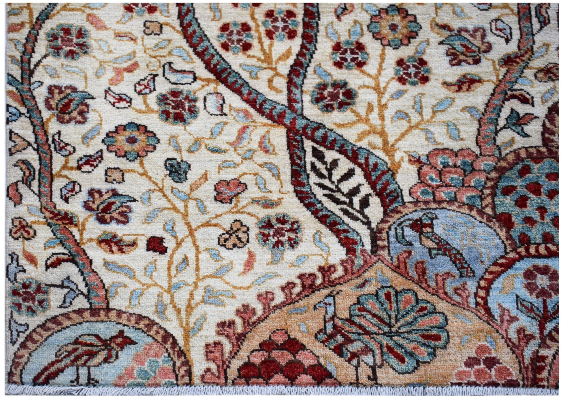 A handwoven Afghan Chobi rug featuring intricate floral patterns and birds in earthy tones.