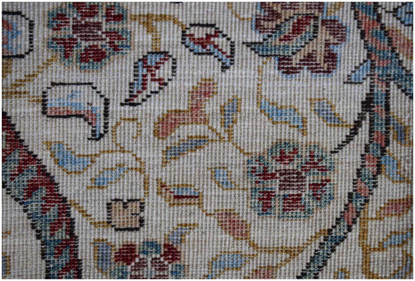A close-up of a handwoven Afghan Chobi rug featuring intricate floral patterns in earthy tones.