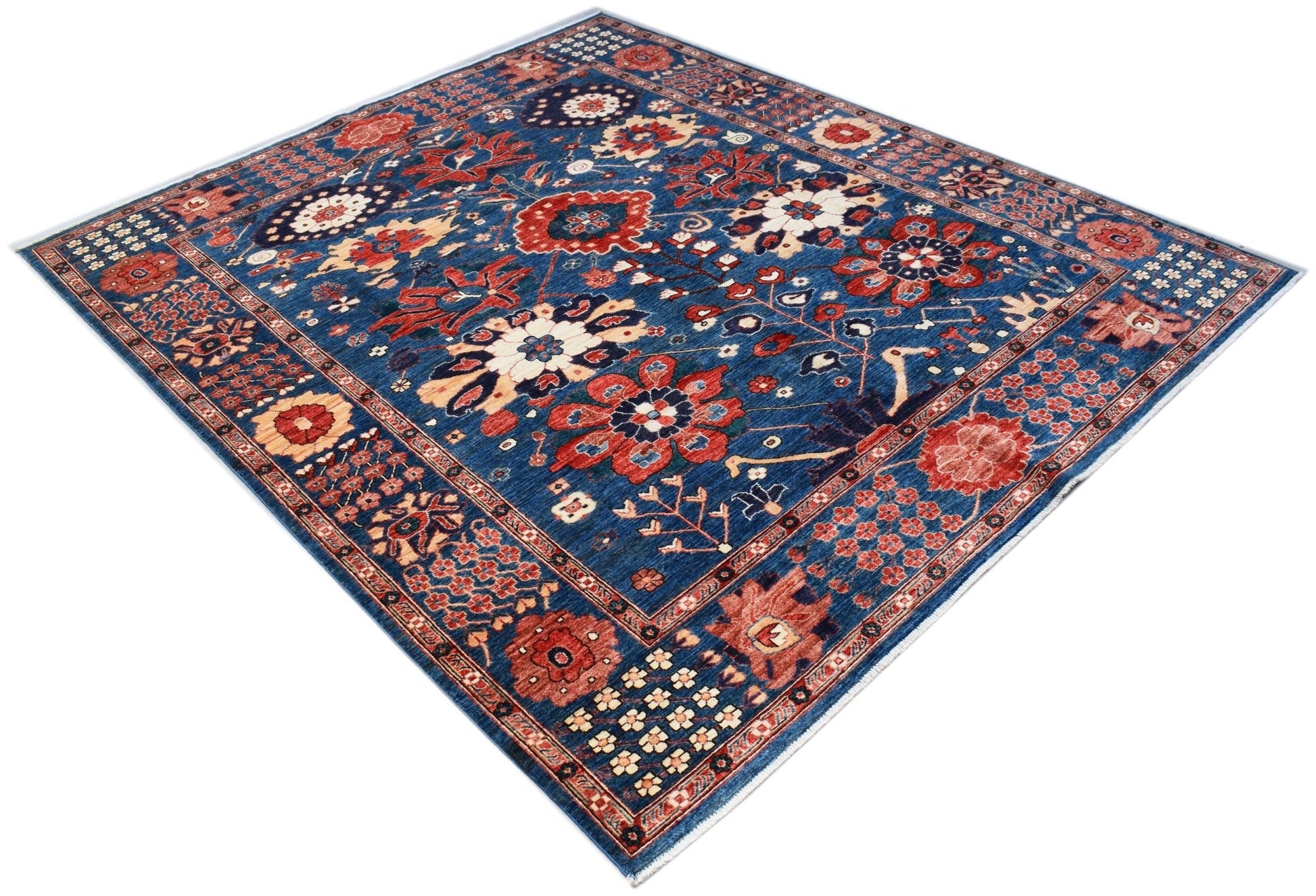 A rectangular Afghan Chobi rug featuring a traditional floral pattern in red and blue tones.