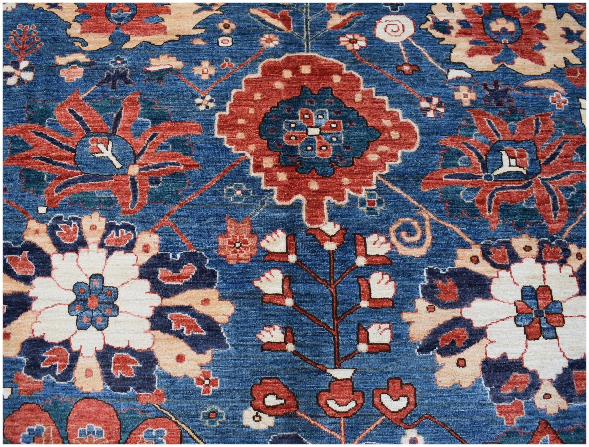 Handwoven Afghan Chobi rug featuring a traditional floral pattern in blue, red, and cream tones.