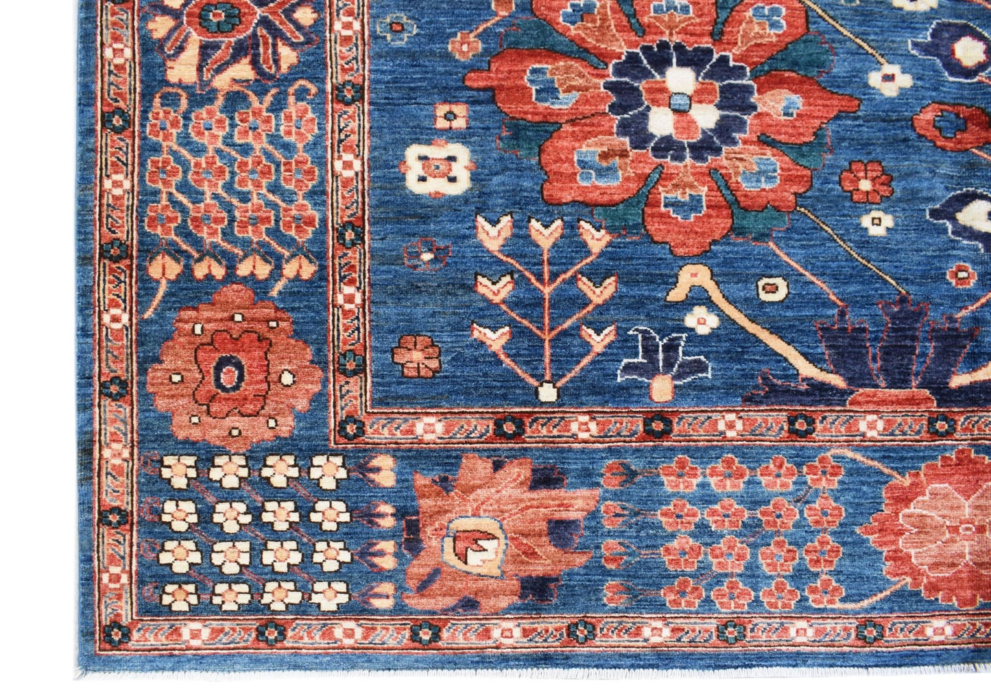 A handmade Afghan Chobi rug featuring a traditional floral pattern in shades of blue and red.