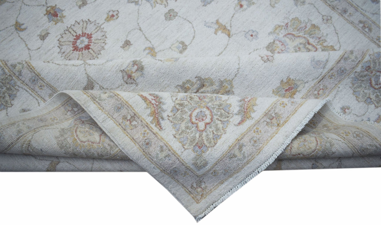 A handwoven Afghan Chobi rug featuring a traditional floral pattern in soft, earthy tones.
