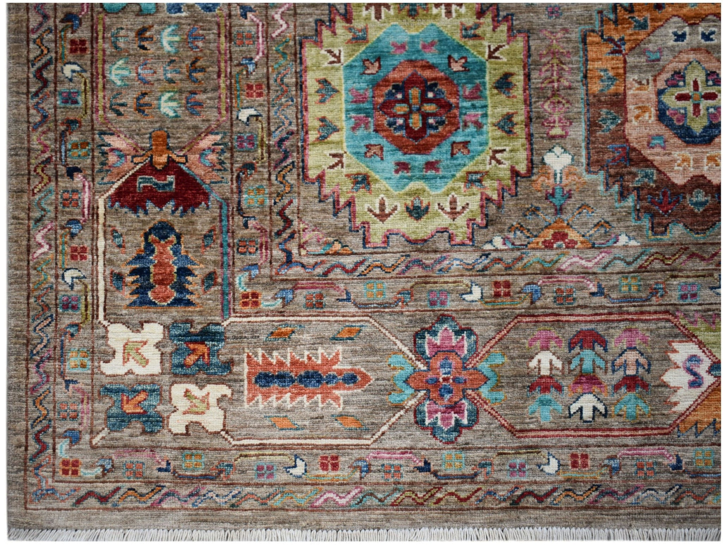 Handwoven Afghan Chobi rug featuring a traditional geometric pattern in earthy and vibrant tones.