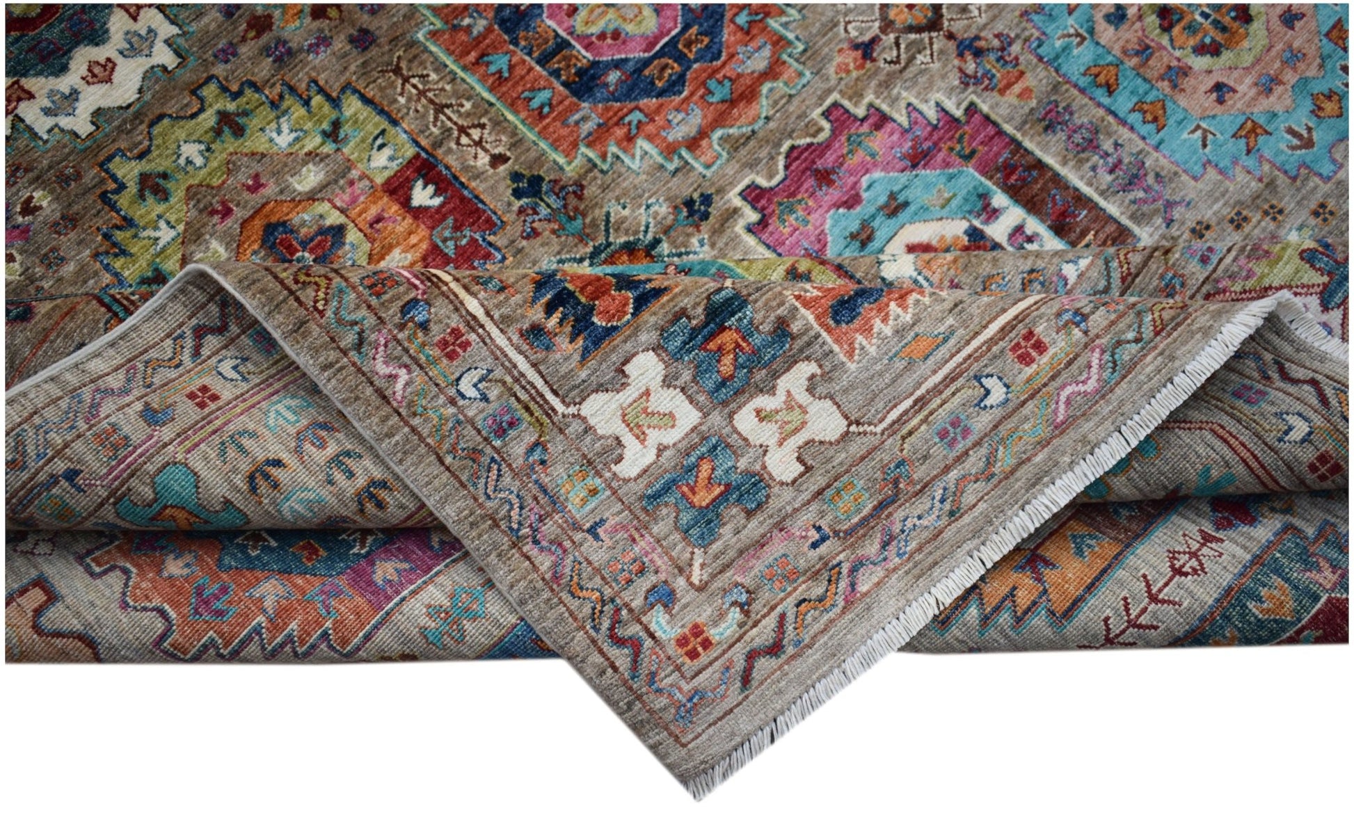 A handwoven Afghan Chobi rug featuring a traditional geometric pattern in vibrant, earthy tones.