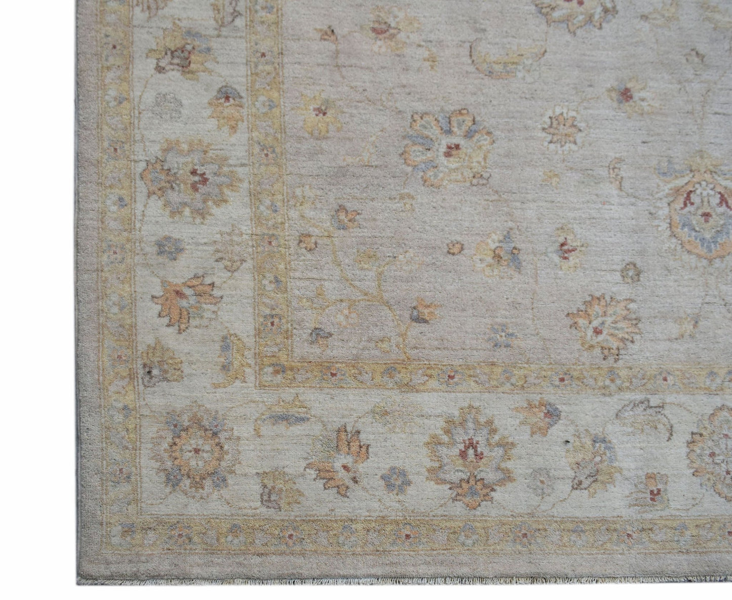 A handwoven Afghan Chobi rug featuring a traditional floral pattern in soft, earthy tones.