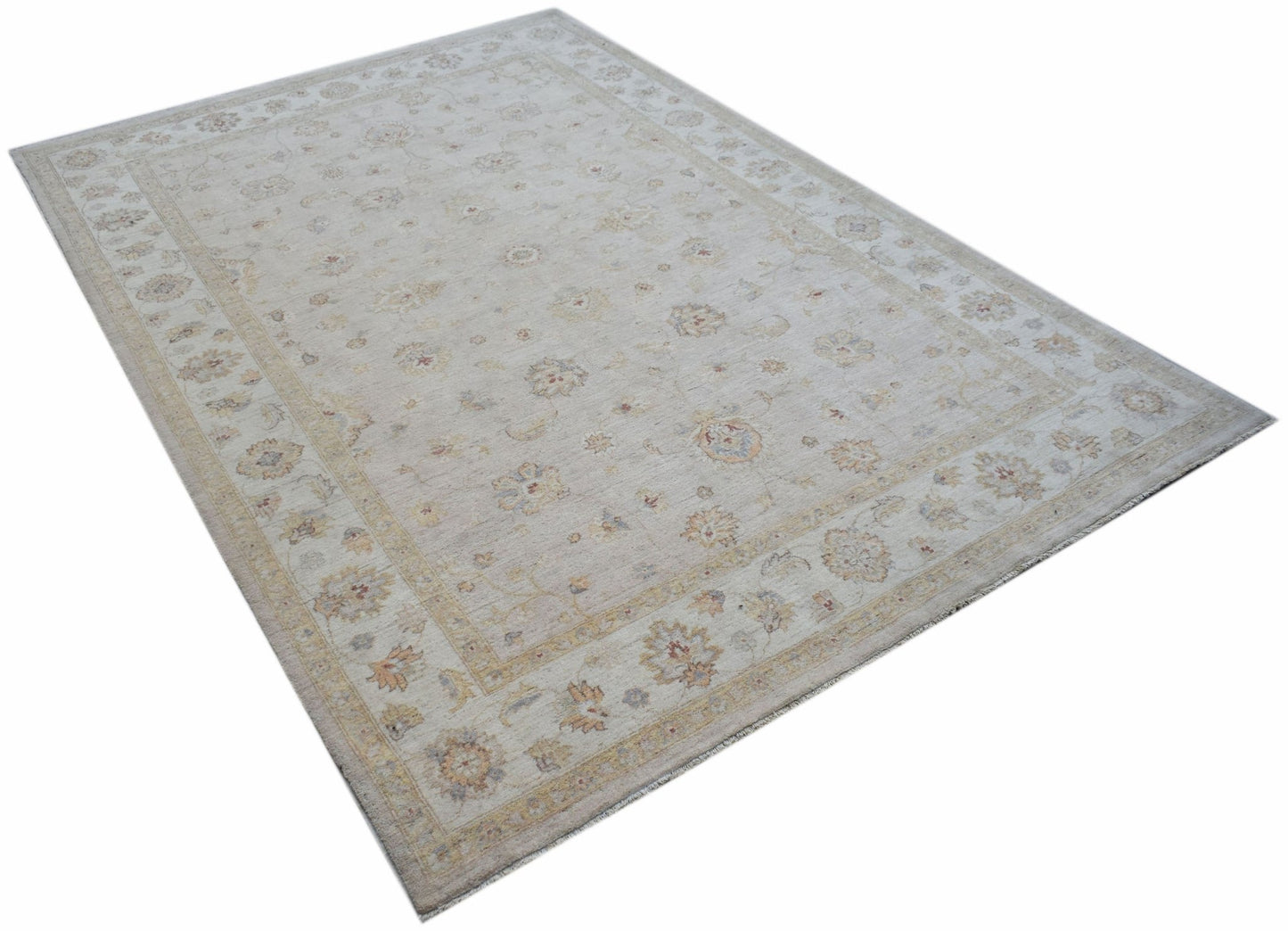 An Afghan Chobi rug featuring a traditional floral pattern in soft, neutral wood tones.
