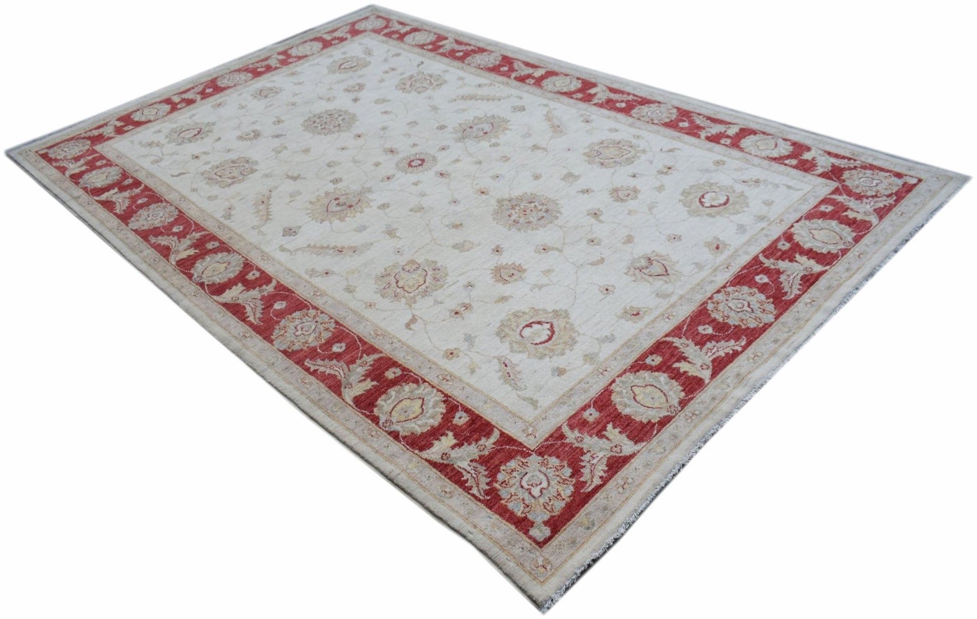 An Afghan Chobi rug featuring a cream field with floral motifs and a wide red border.