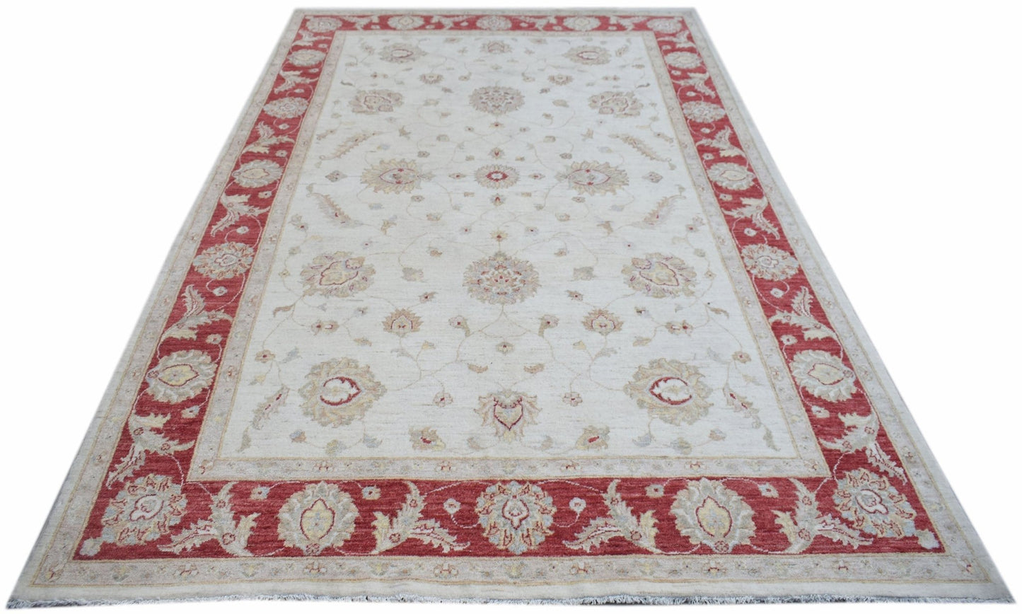 Handwoven Afghan Chobi rug featuring a cream field with floral motifs and a red border.