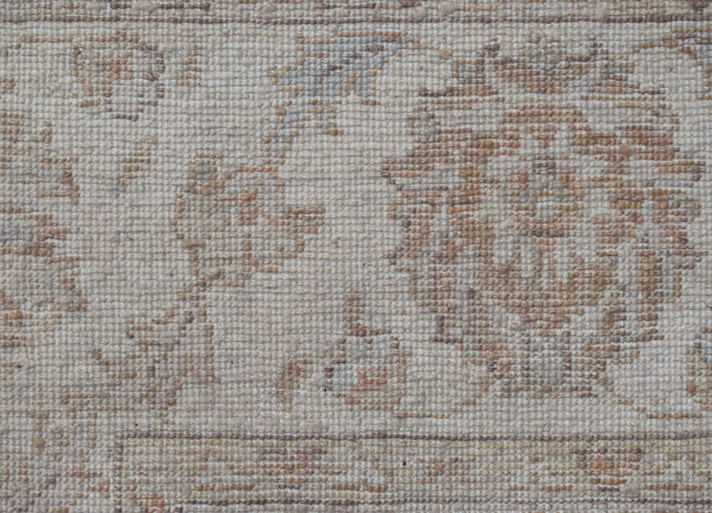 A close-up of a handwoven Afghan Chobi rug featuring a traditional floral pattern in neutral tones.