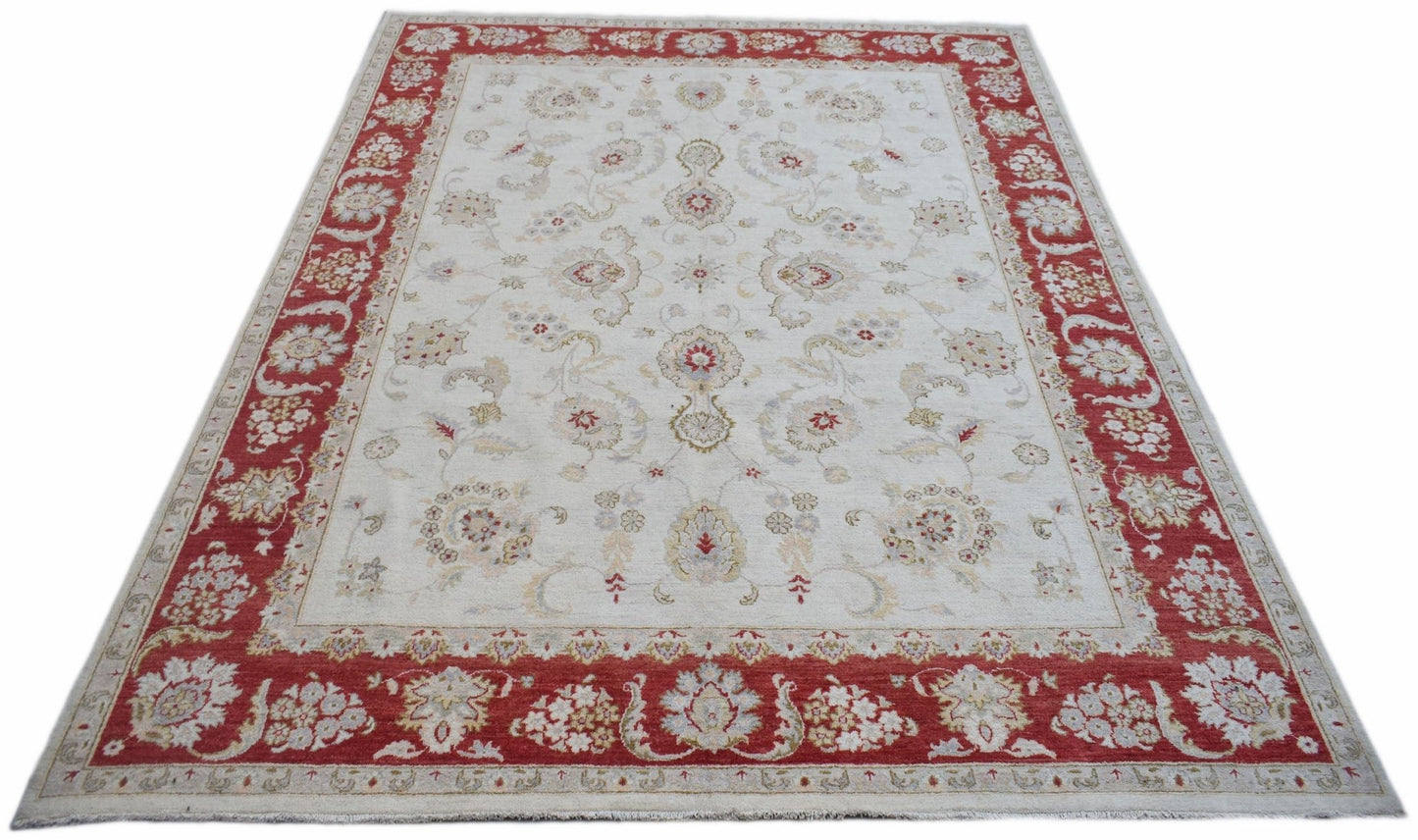 A rectangular Afghan Chobi rug featuring a cream field with floral patterns and a red border.