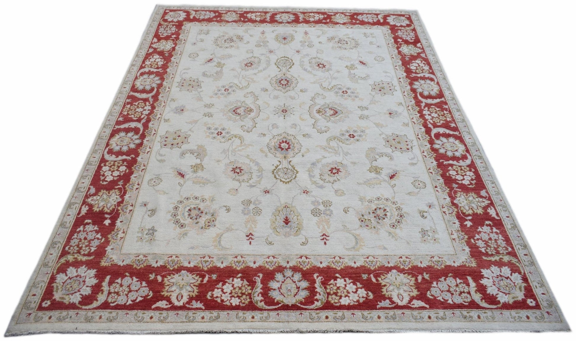 A rectangular Afghan Chobi rug featuring a cream field with floral patterns and a red border.