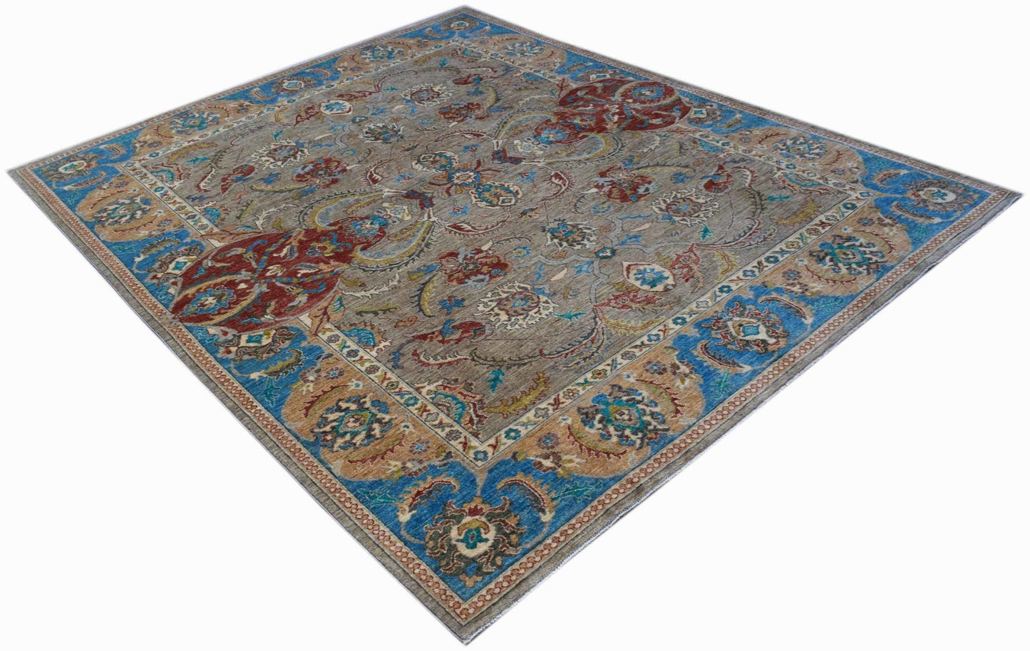 A rectangular Afghan Chobi rug featuring a traditional floral pattern in blue, red, and tan tones.