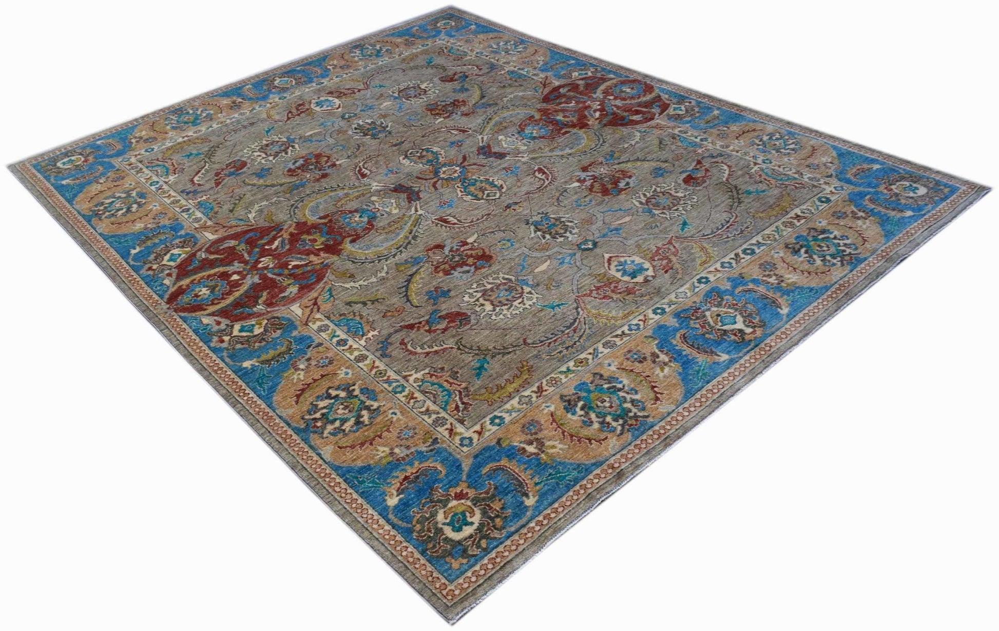 A rectangular Afghan Chobi rug featuring a traditional floral pattern in blue, red, and tan tones.