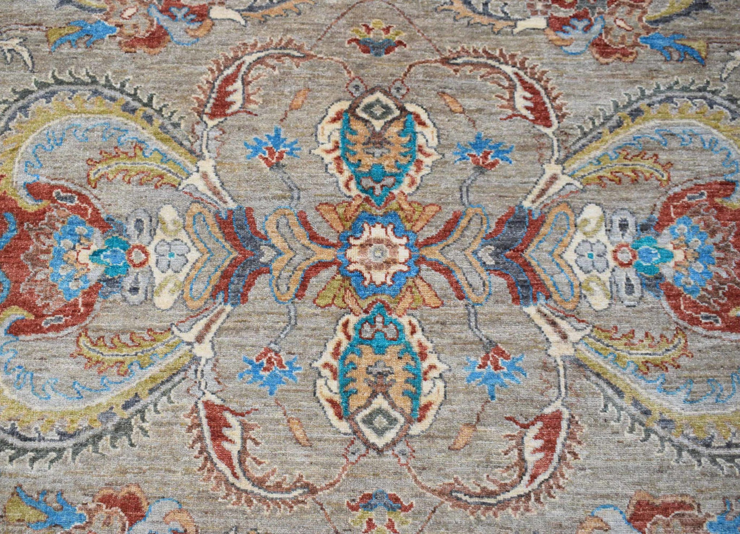 A handwoven Afghan Chobi rug featuring a traditional floral medallion pattern in earthy tones.