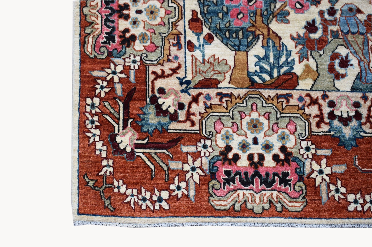 A handmade Afghan Chobi rug featuring a detailed hunting scene with floral and animal motifs.
