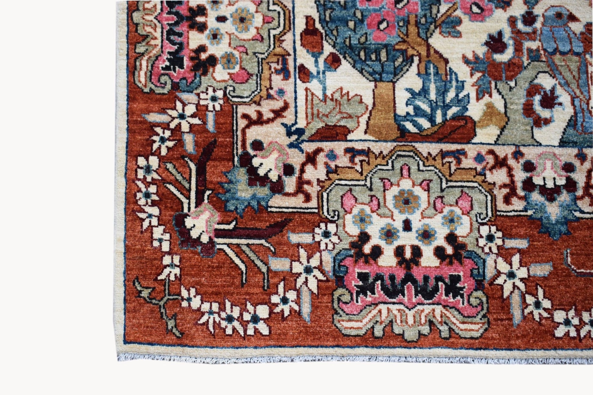 A handmade Afghan Chobi rug featuring a detailed hunting scene with floral and animal motifs.