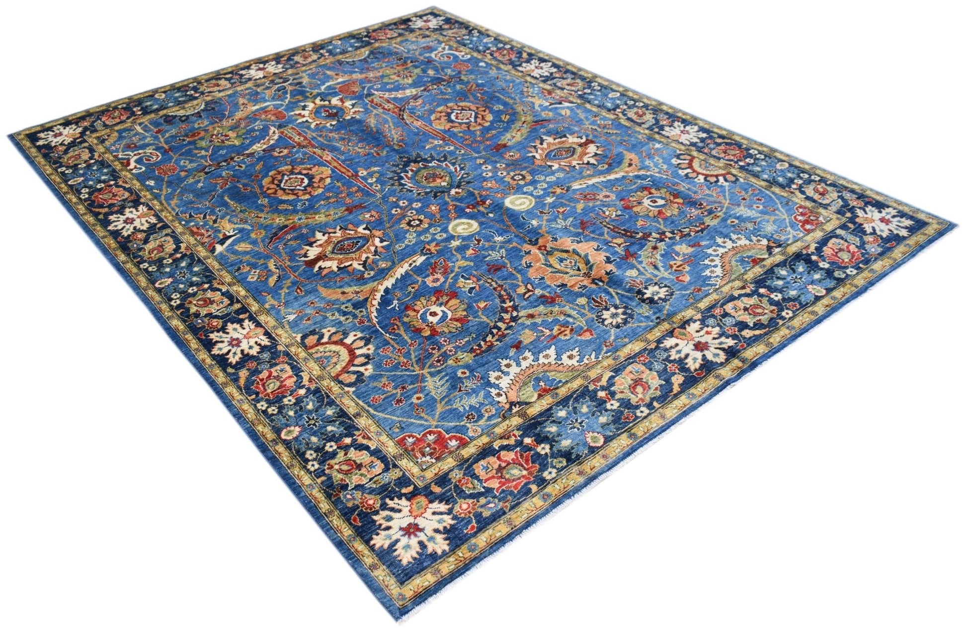 A rectangular Afghan Chobi rug featuring intricate floral patterns in blue, red, and beige tones.