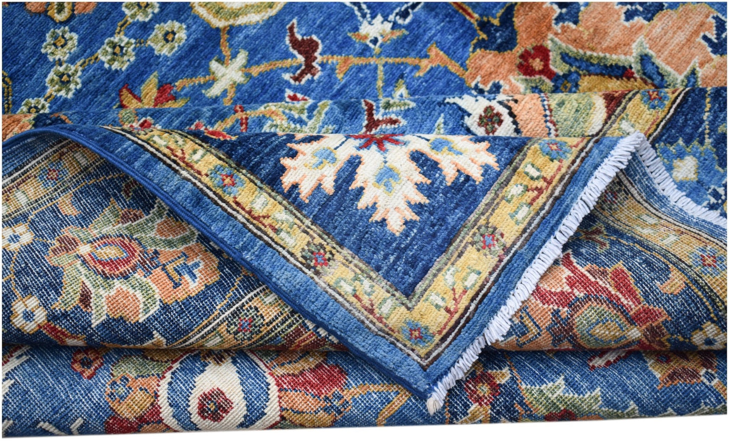 A handwoven Afghan Chobi rug featuring a traditional floral pattern in blue, red, and gold tones.