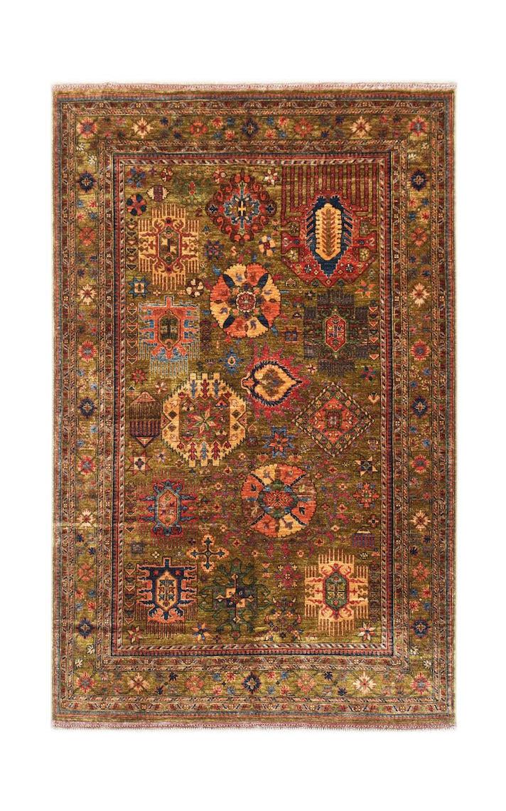 An Afghan Chobi rug featuring a traditional geometric pattern in earthy tones on a wool pile.