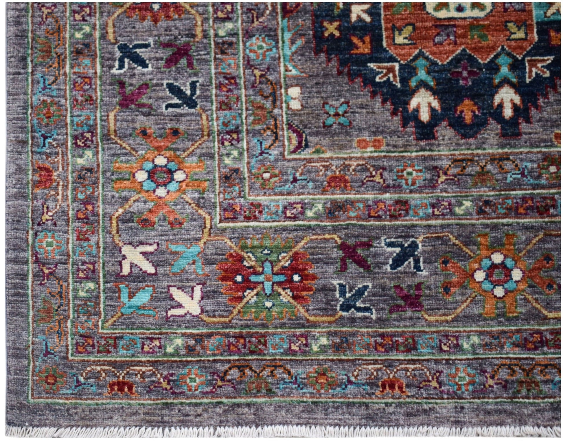 A handwoven Afghan Chobi rug featuring a grey field with intricate floral and geometric patterns.