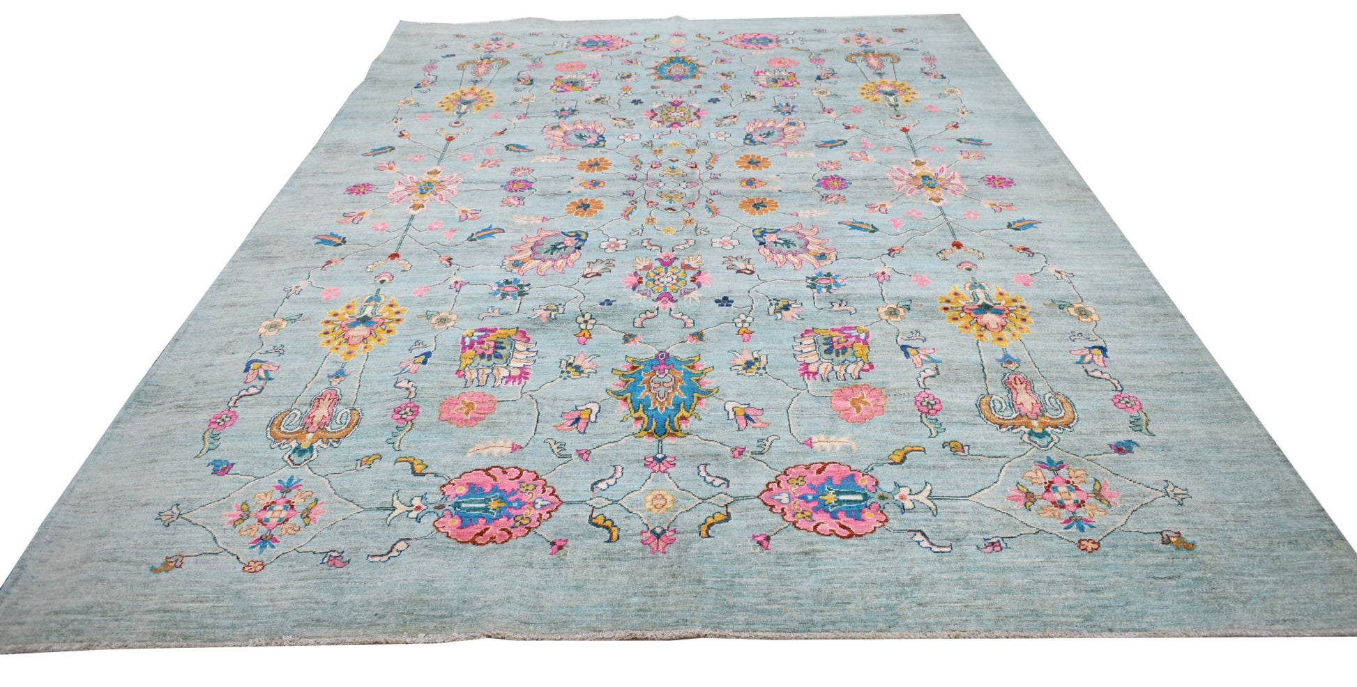 A handwoven Afghan Chobi rug featuring a light blue field with colorful floral and vine patterns.