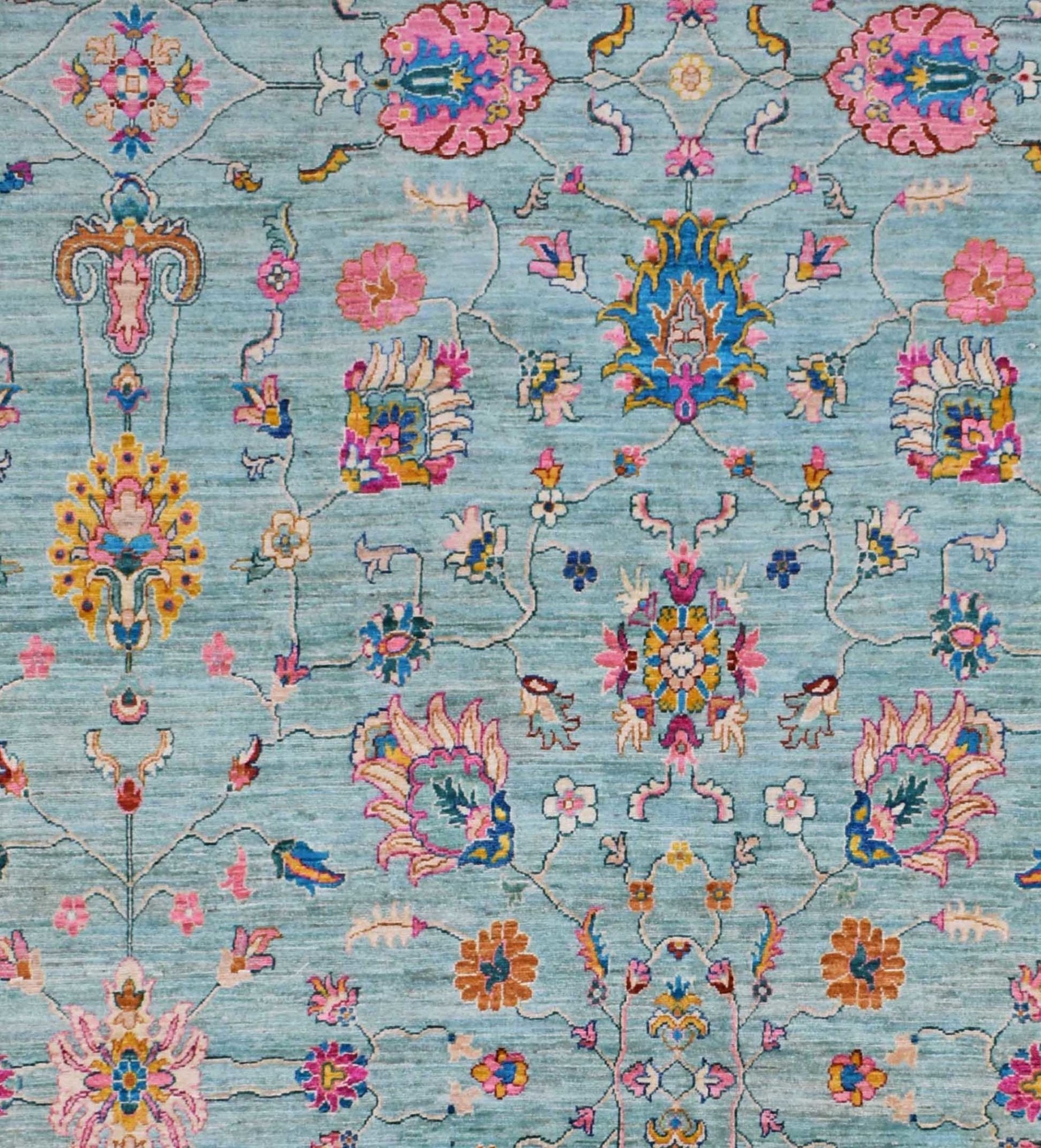 An Afghan Chobi rug featuring a traditional floral pattern in shades of blue, pink, and gold.