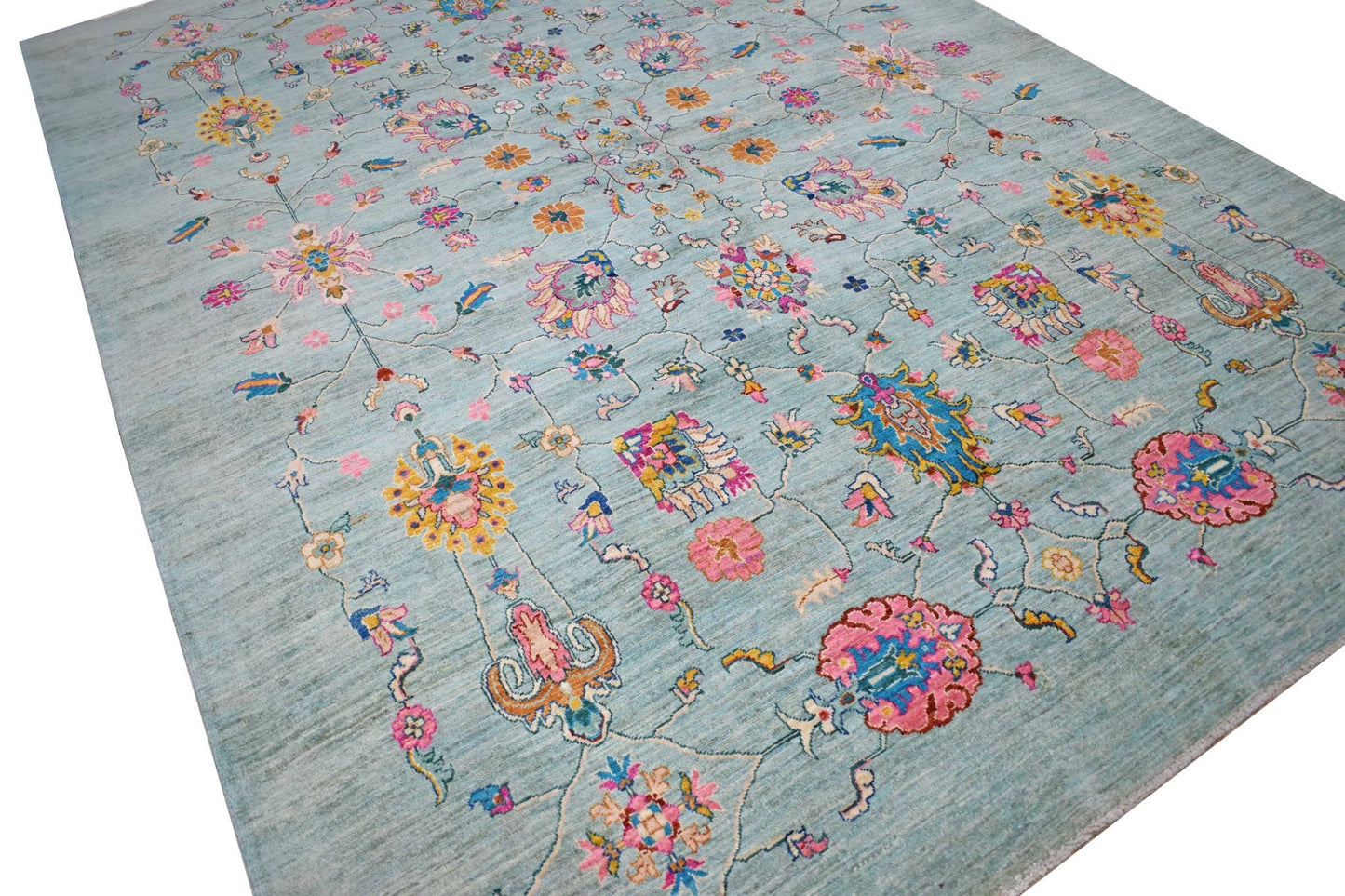 Handwoven Afghan Chobi rug featuring a light blue field with colorful floral and vine motifs.