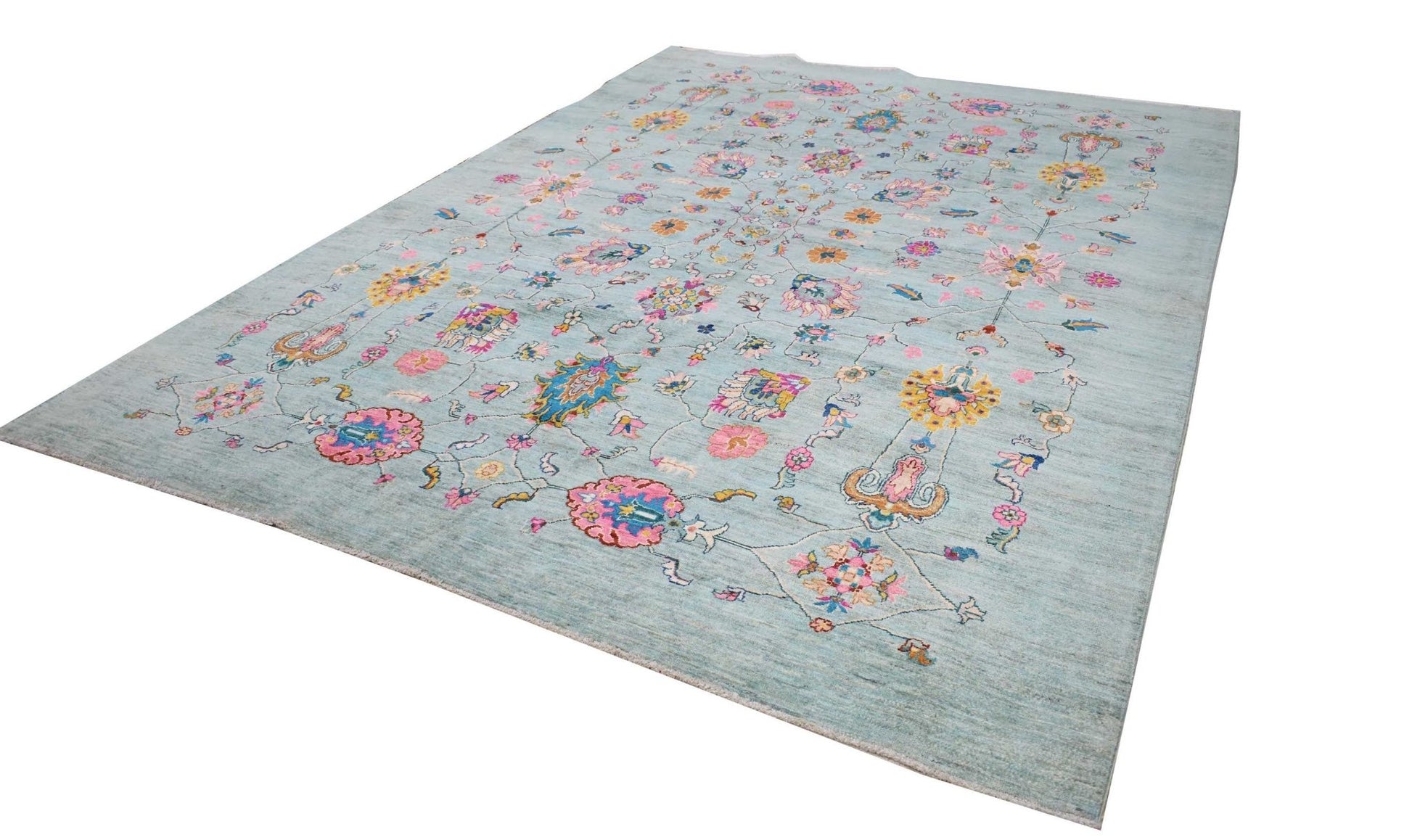 An Afghan Chobi rug featuring a light blue field with colorful floral and geometric motifs.