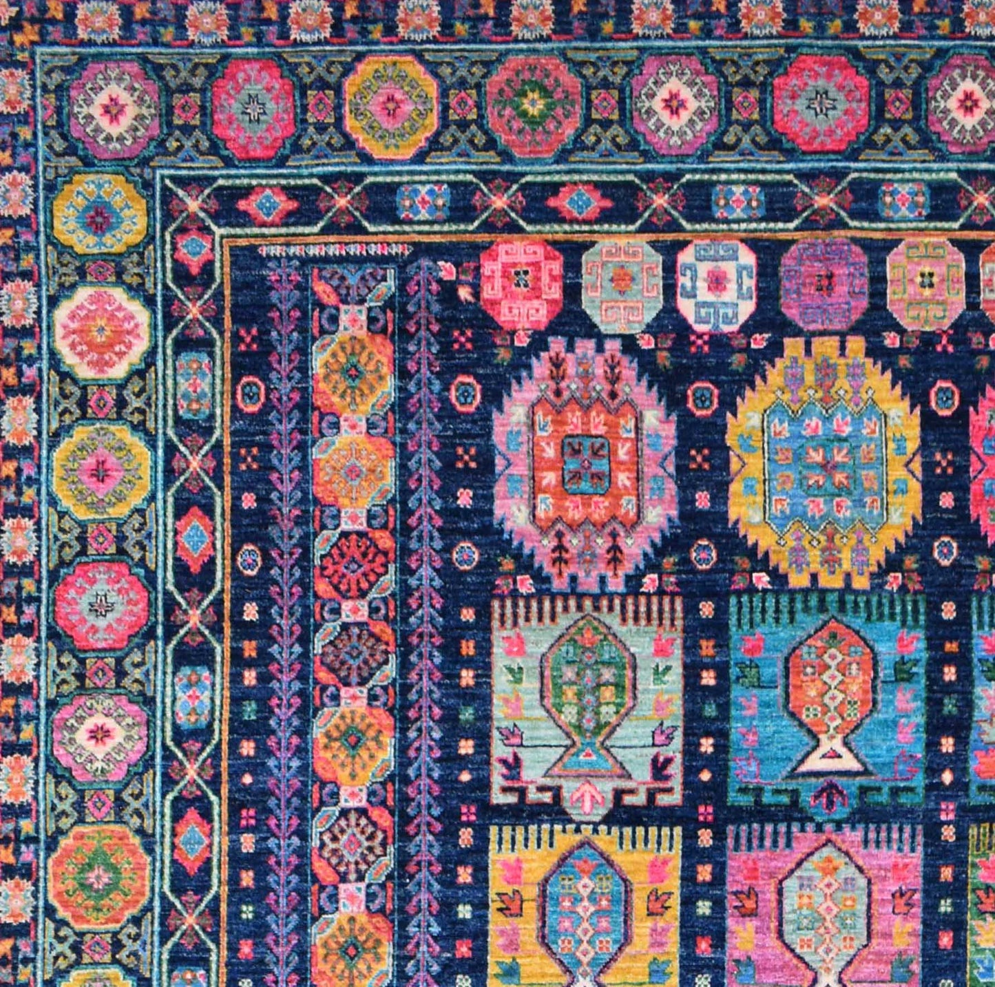 A handwoven Afghan Chobi rug featuring intricate geometric patterns in vibrant multicolored wool.