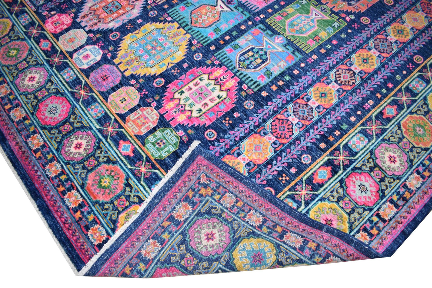 A vibrant, handwoven Afghan Chobi rug featuring intricate geometric patterns in a colorful palette.