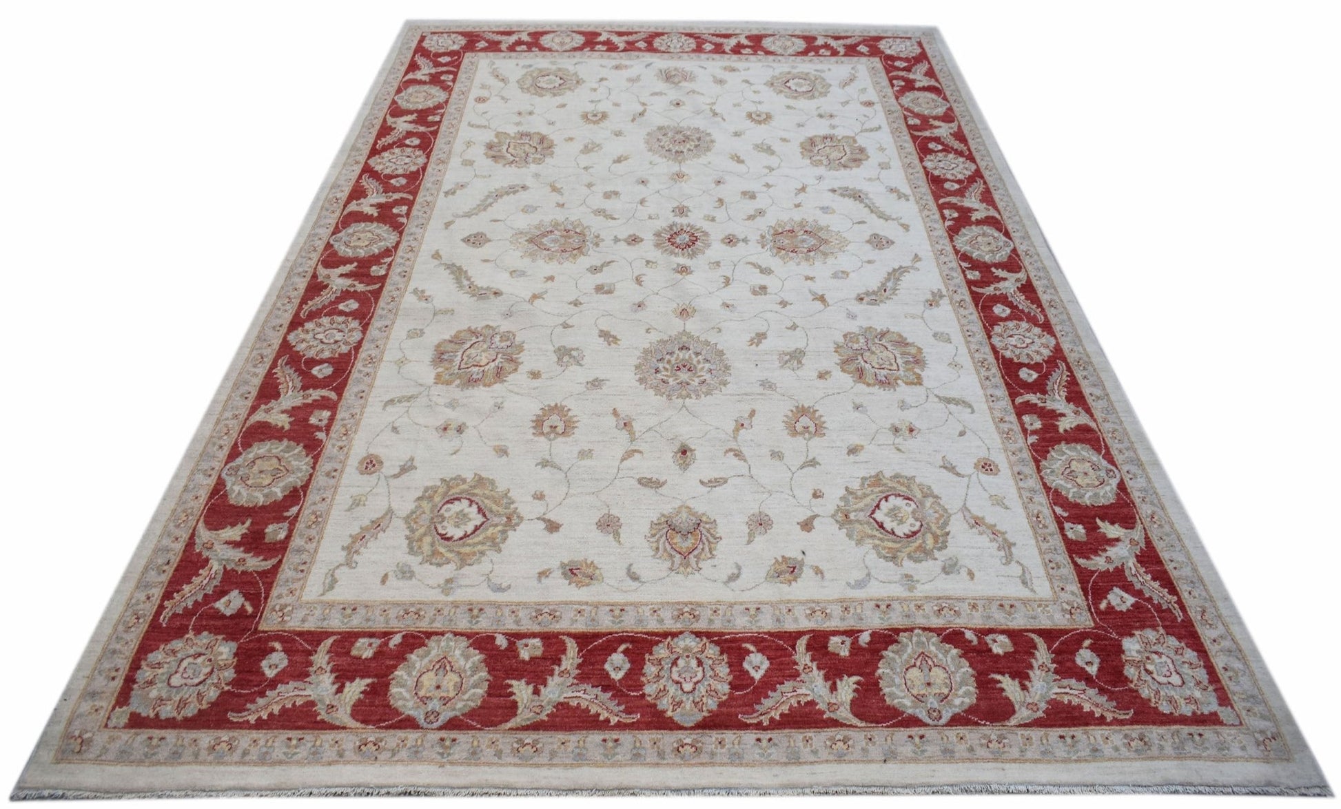A rectangular Afghan Chobi rug featuring a cream field with floral motifs and a red border.