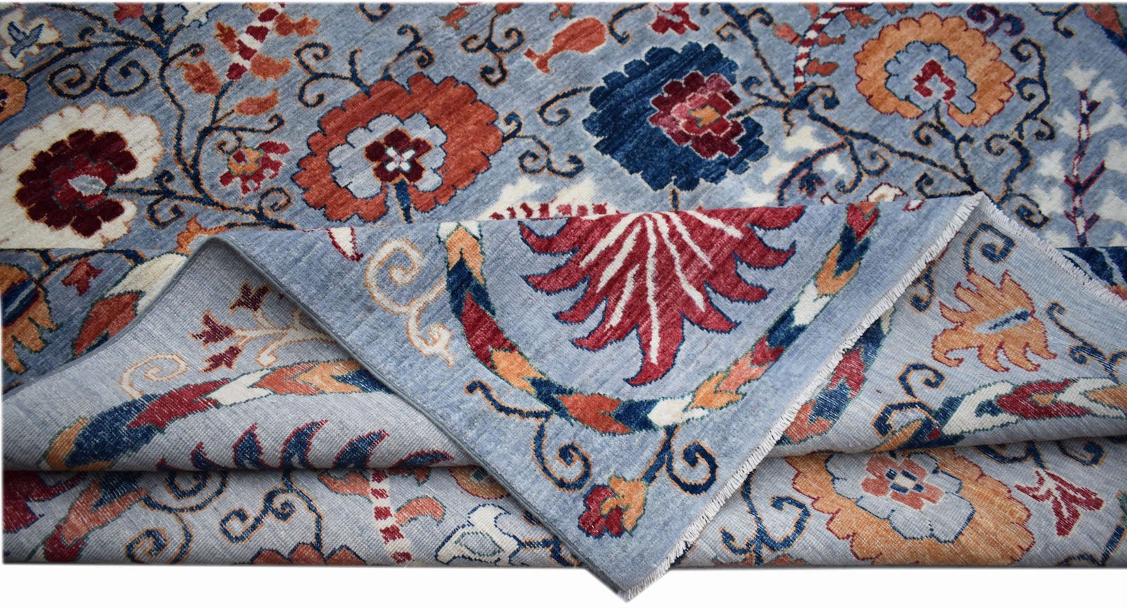 A handwoven Afghan Chobi rug featuring a floral pattern in blue, red, and orange tones.