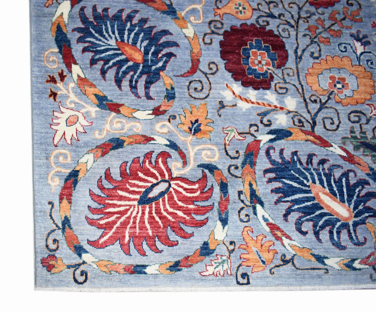 Handwoven Afghan Chobi rug featuring a traditional floral pattern in blue, red, and orange tones.
