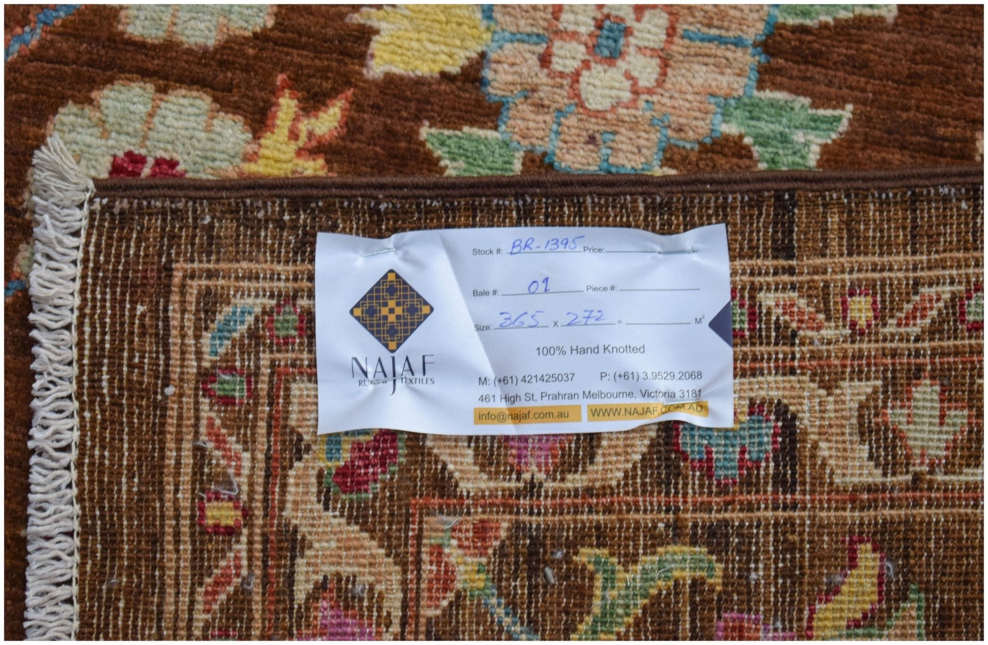 A hand-knotted Afghan Chobi rug featuring a traditional floral pattern in warm earthy tones.