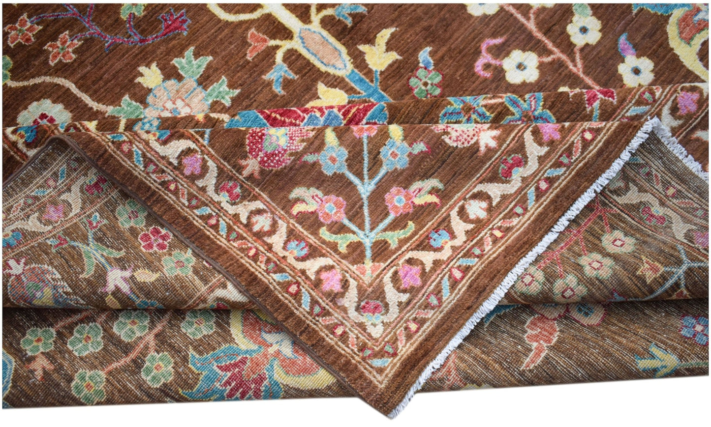 A handwoven Afghan Chobi rug featuring a traditional floral pattern in earthy brown tones.