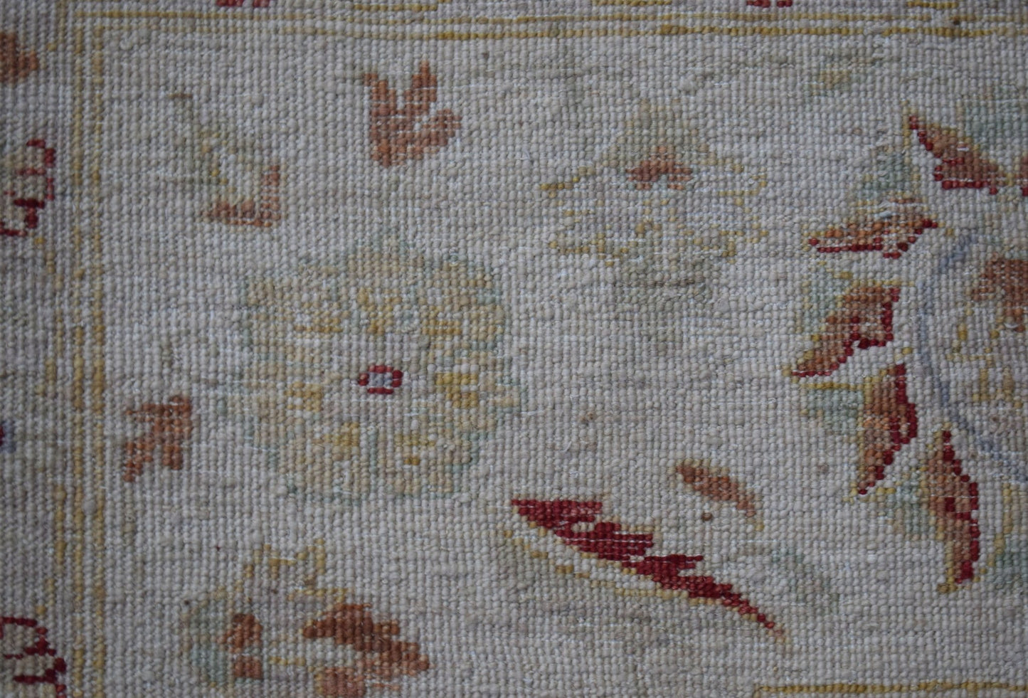 A close-up of an Afghan Chobi rug featuring traditional floral patterns in earthy tones.