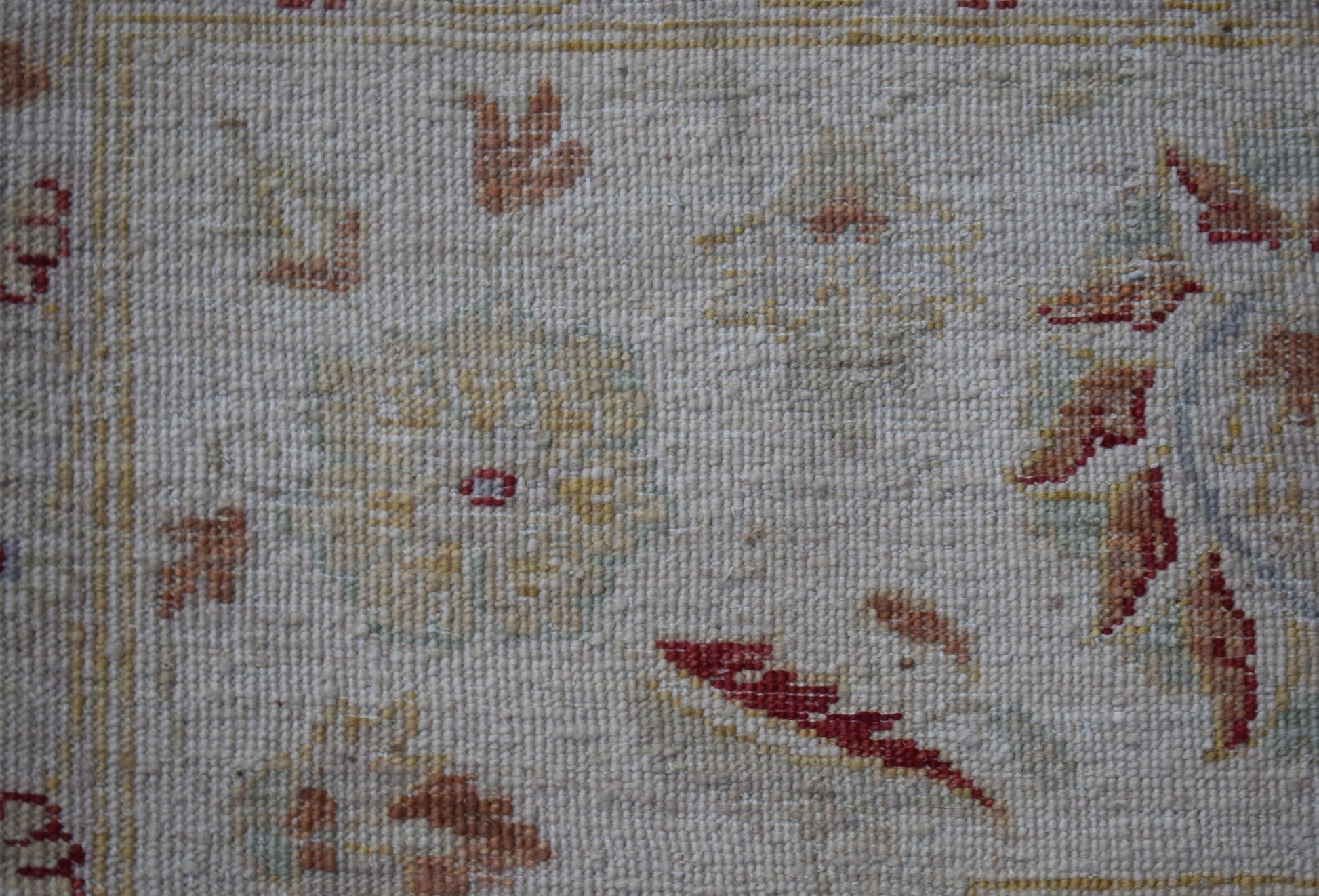 A close-up of an Afghan Chobi rug featuring traditional floral patterns in earthy tones.
