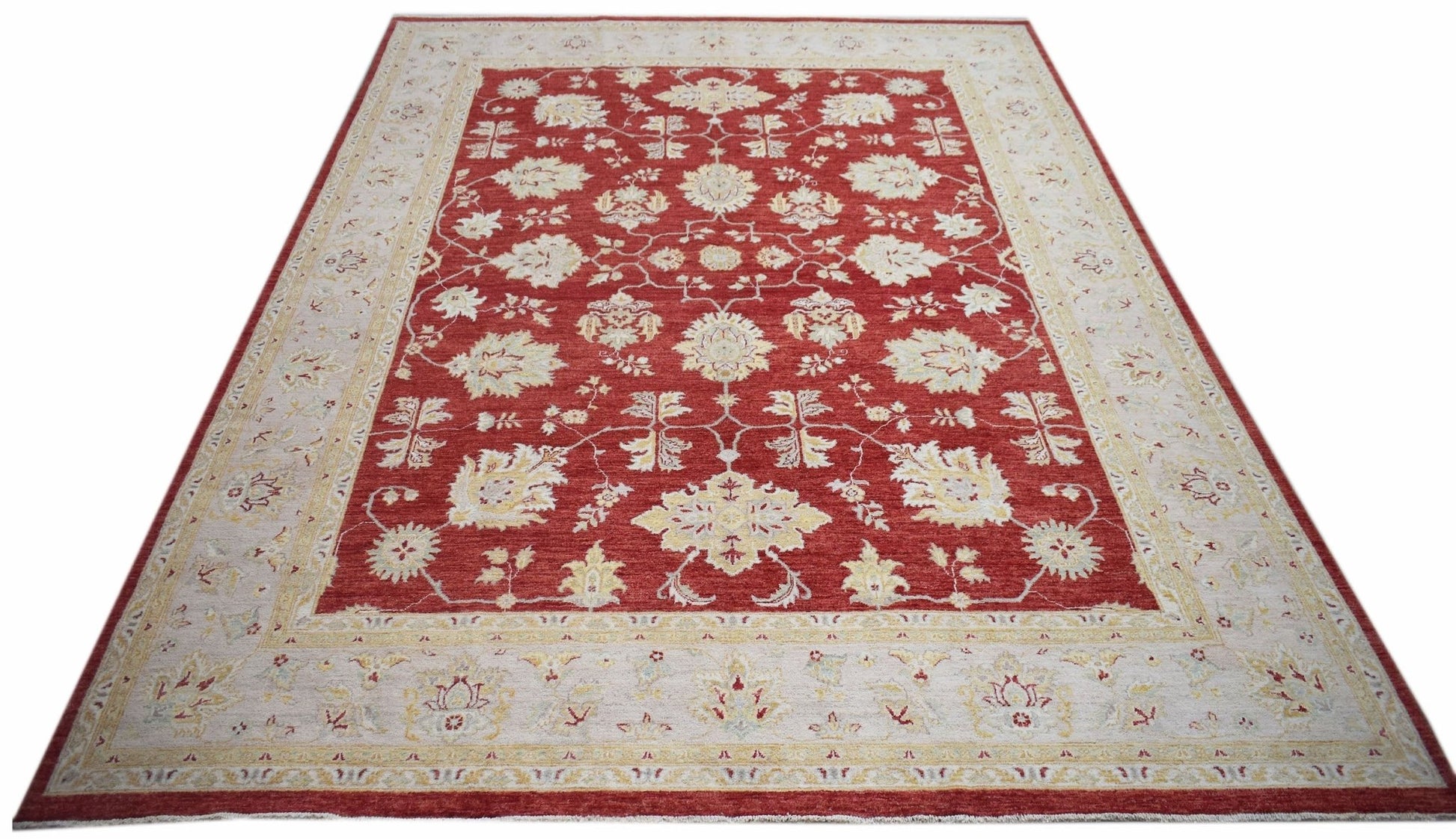 A rectangular Afghan Chobi rug featuring a traditional floral pattern in red and cream tones.