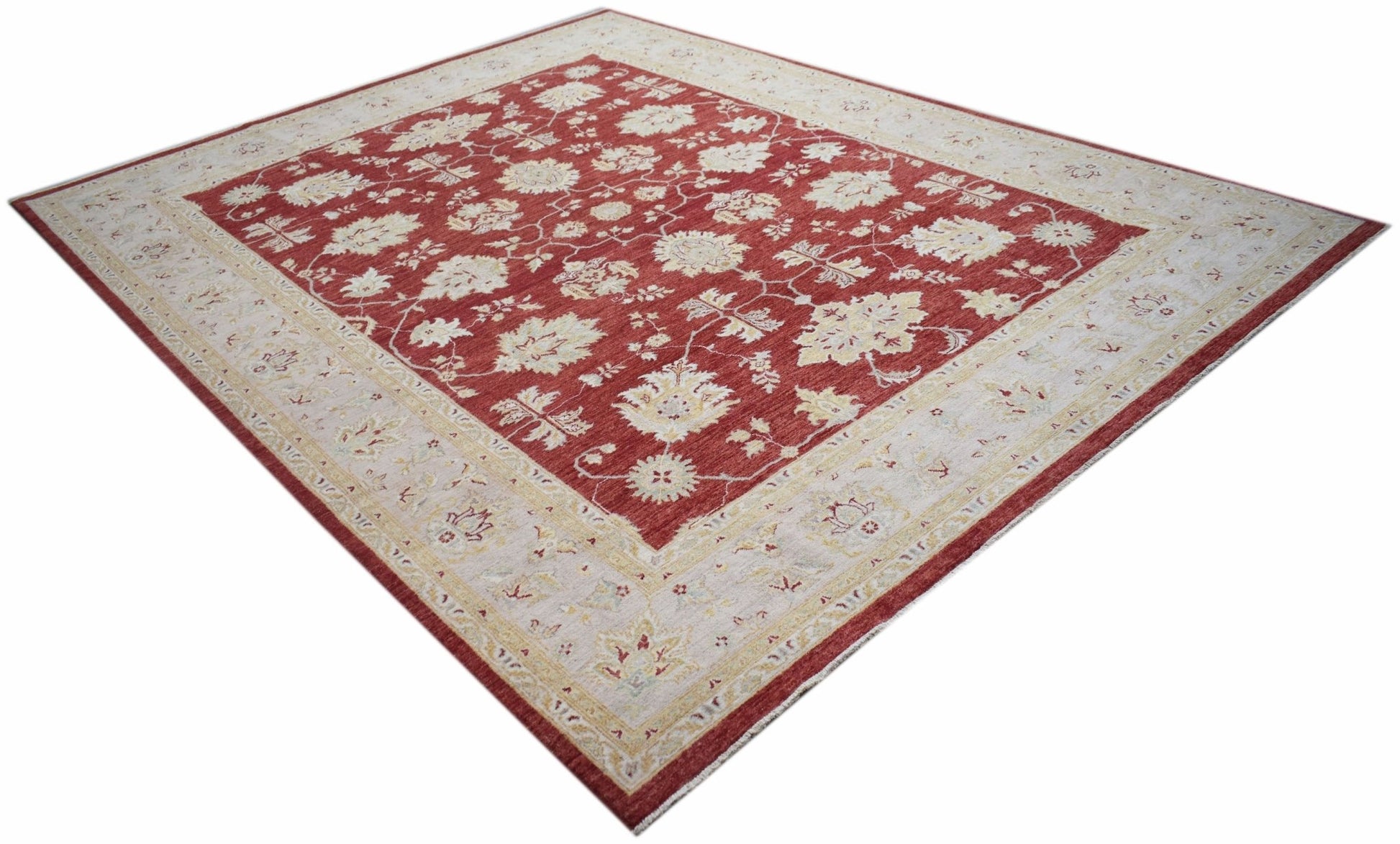 A rectangular Afghan Chobi rug featuring a traditional floral pattern in red and cream tones.