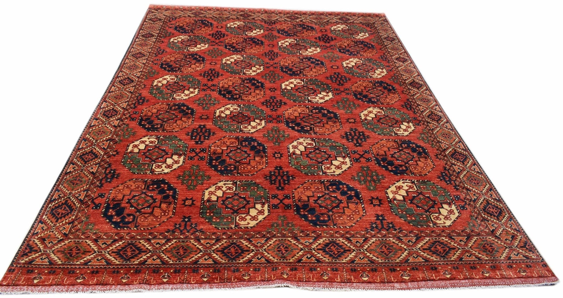 Handwoven Afghan Chobi rug featuring a traditional geometric pattern in warm earthy tones.