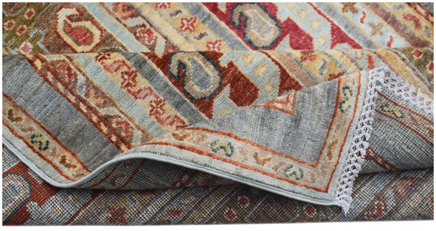 A handwoven Afghan Chobi runner featuring traditional patterns in muted earth tones and wool.