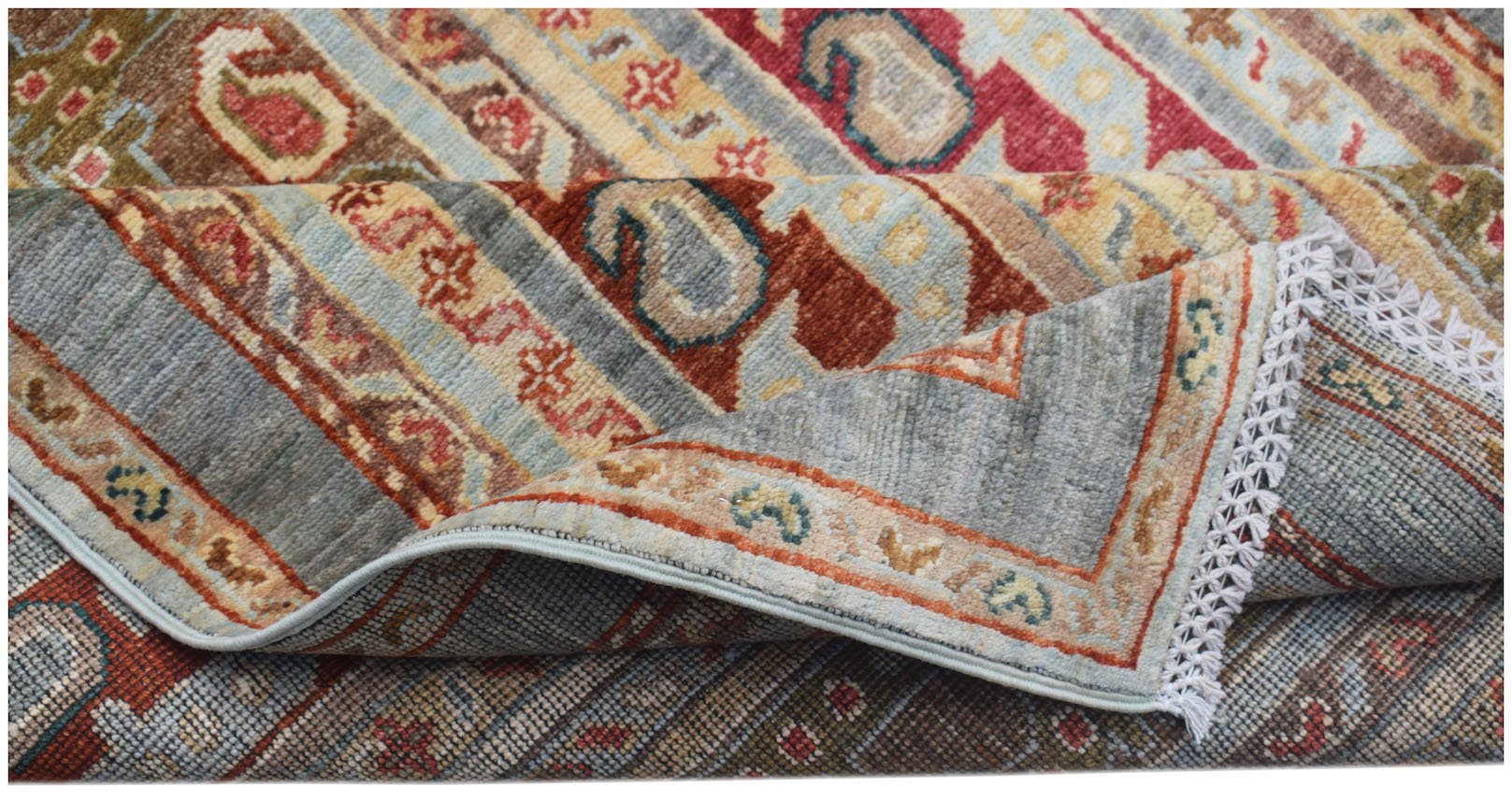 A handwoven Afghan Chobi runner featuring traditional patterns in muted earth tones and wool.