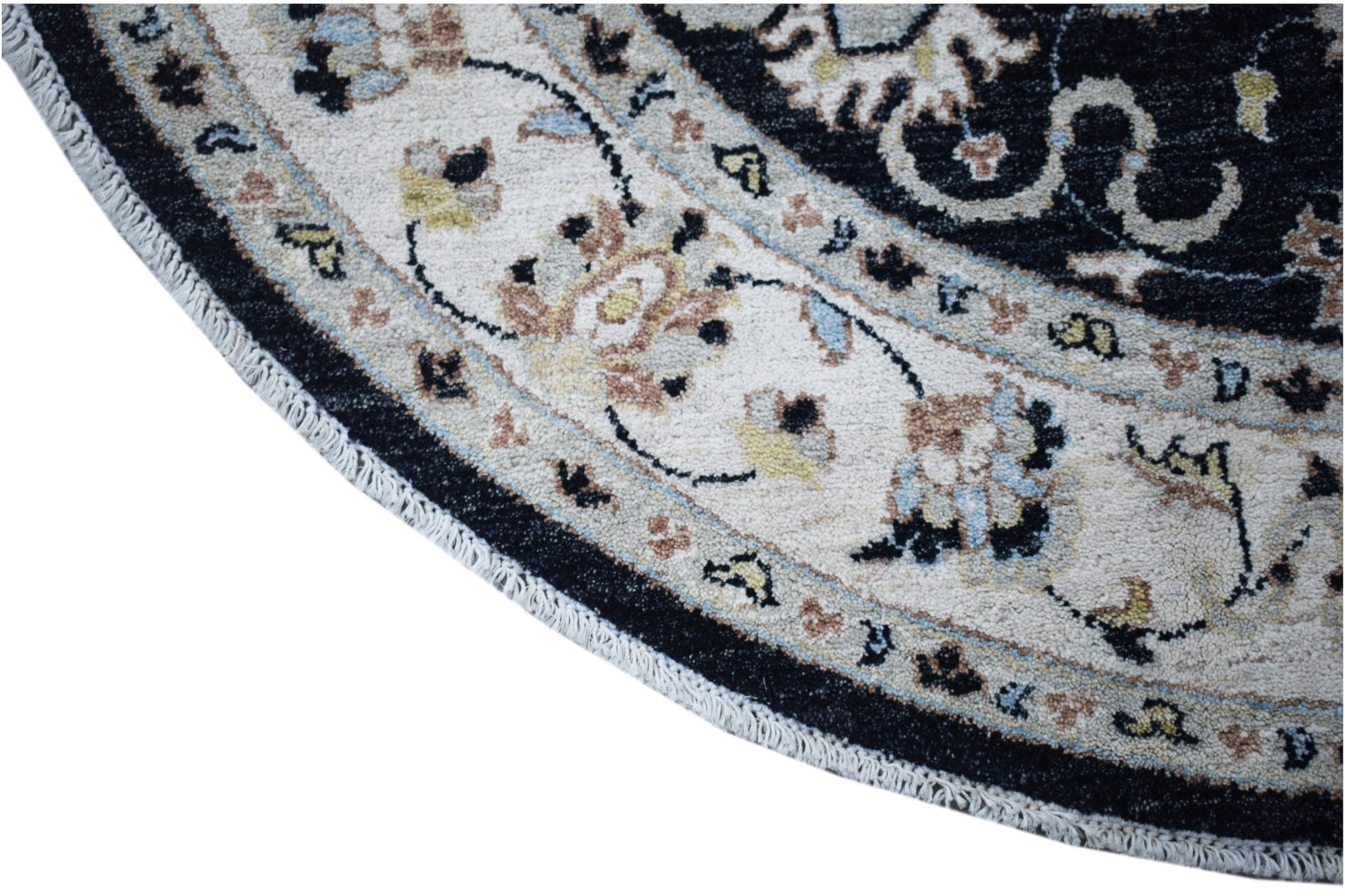 A round, handwoven Afghan Chobi rug featuring intricate floral patterns in a cream and black border.