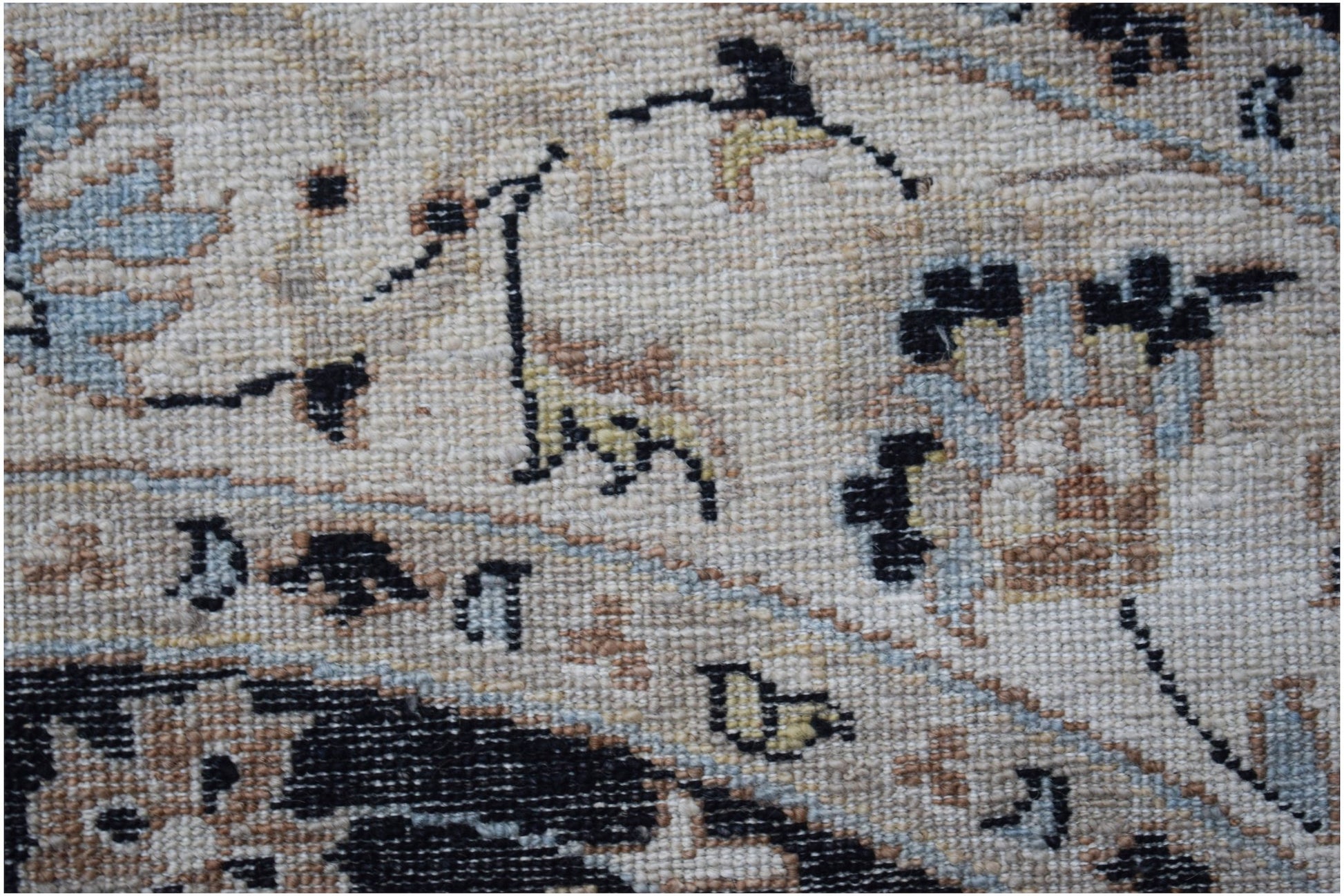 A close-up of a handwoven Afghan Chobi rug featuring intricate floral patterns in earthy tones.