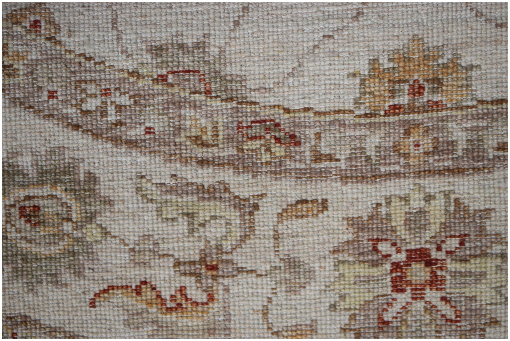 A close-up of a handwoven Afghan Chobi rug featuring traditional floral patterns in earthy tones.