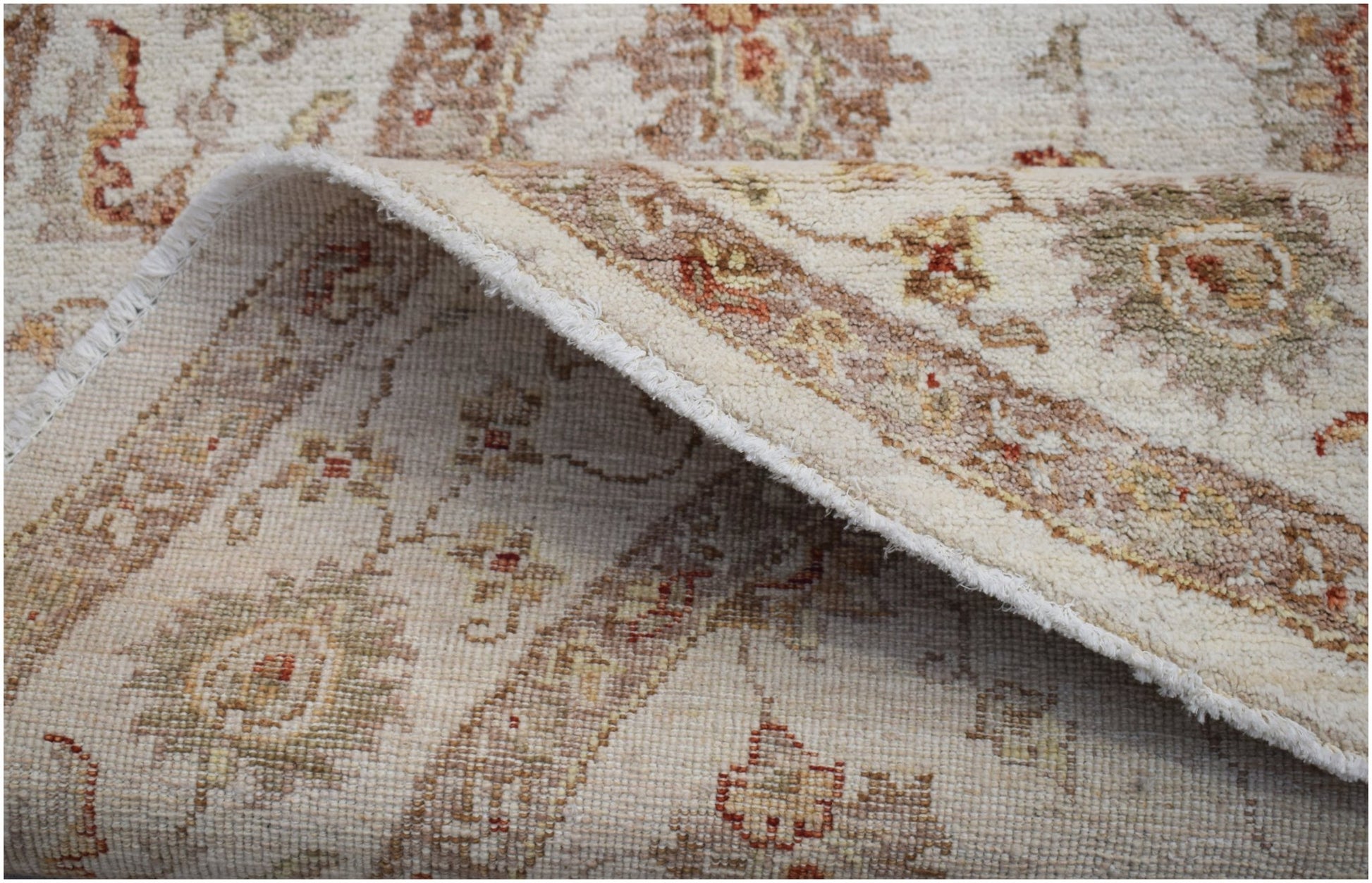 A handwoven Afghan Chobi rug with a traditional floral pattern in soft, earthy wood tones.