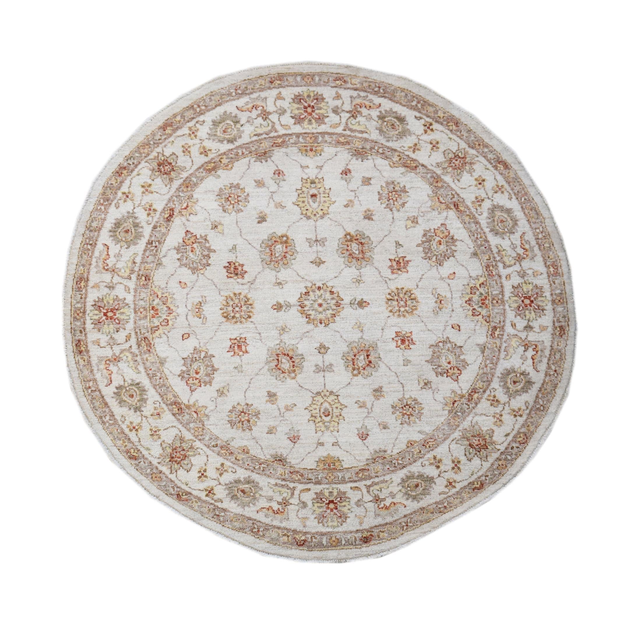 A round Afghan Chobi rug featuring a traditional floral pattern in soft, earthy tones.